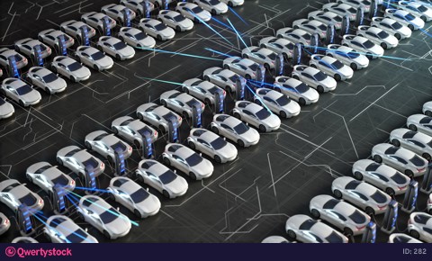 Parking lot with electric charging stations for electric vehicles. Aerial view of new electric self driving cars on car on a huge car dealership parking lot.