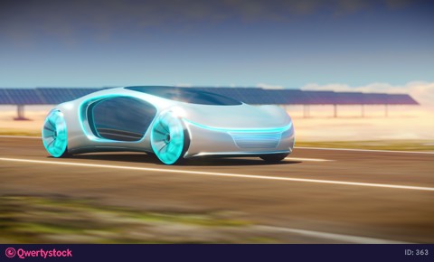 The eco-friendly electric car rides along solar panels.