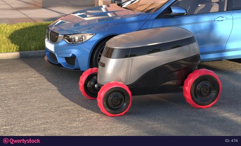 Autonomous delivery robot drives on sunset street