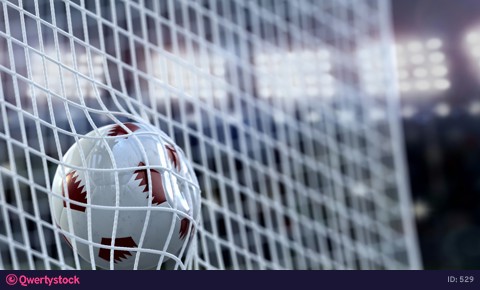 A soccer ball flies into the net. Stadium with floodlights. 3D rendering.