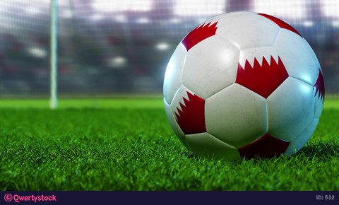 Soccer ball rolls out on the green grass. Close-up on the background of the football goal. Bright flashbulbs. 3D rendering.