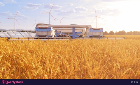 Harvesters on field with solar panels and windmills in the background 4K